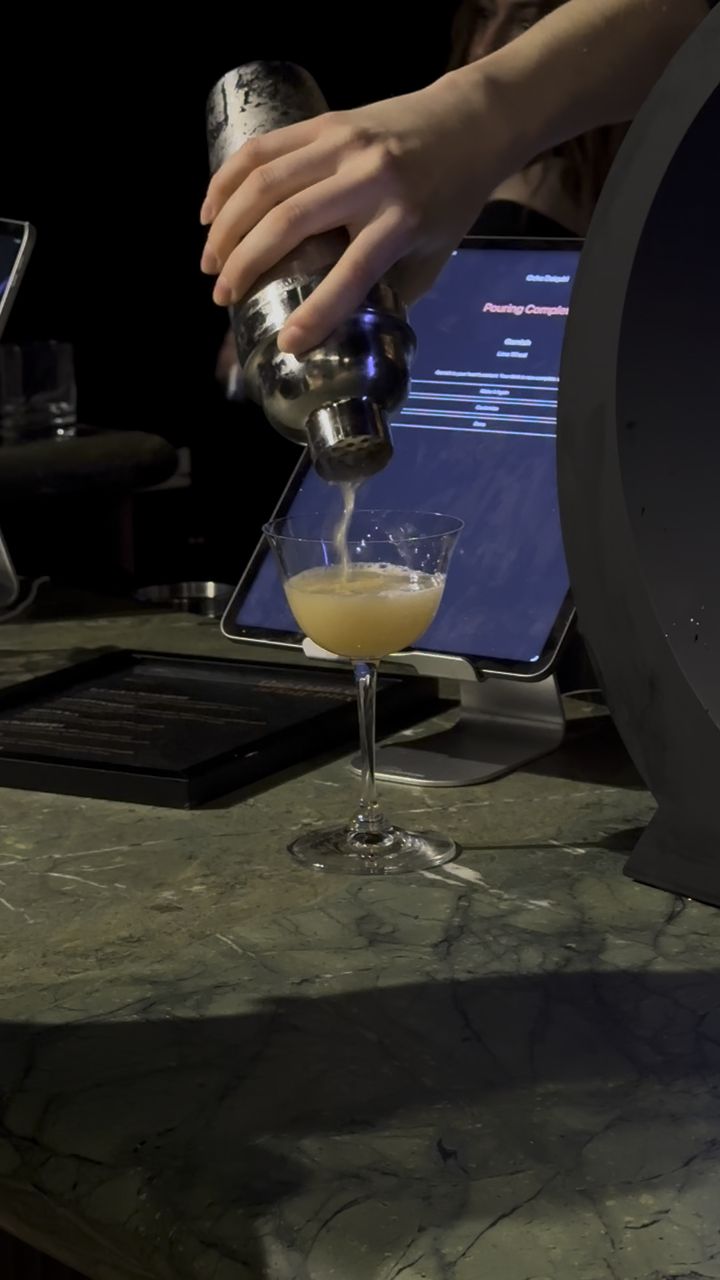 Barsys bartender finishing a cocktail alongside the AI machine